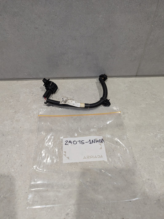 Automotive wiring harness connector assembly with black connectors and plastic bag labeled 24075-1NK0A