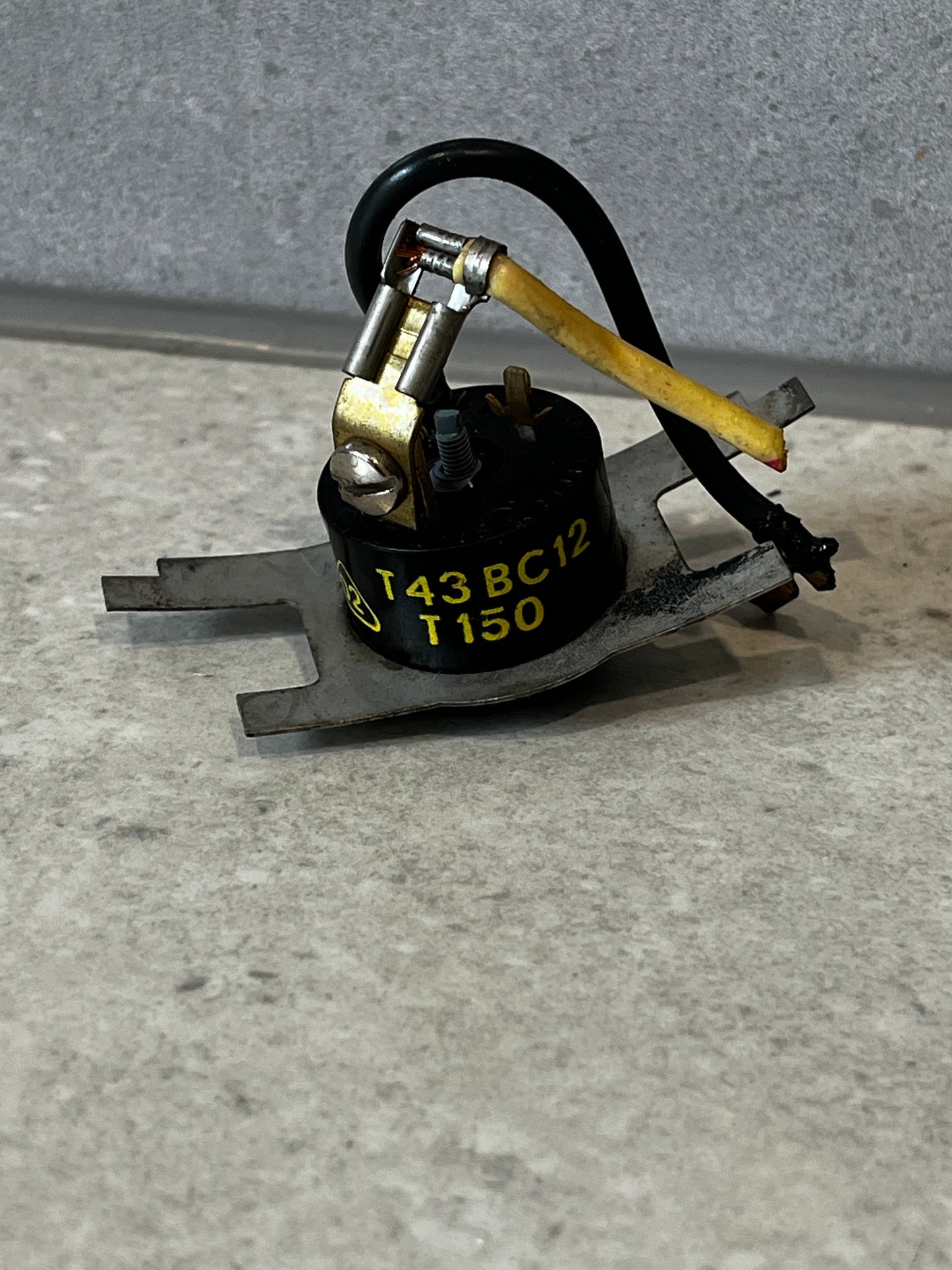 Front view of metal high-temperature thermal switch with wiring and connectors
