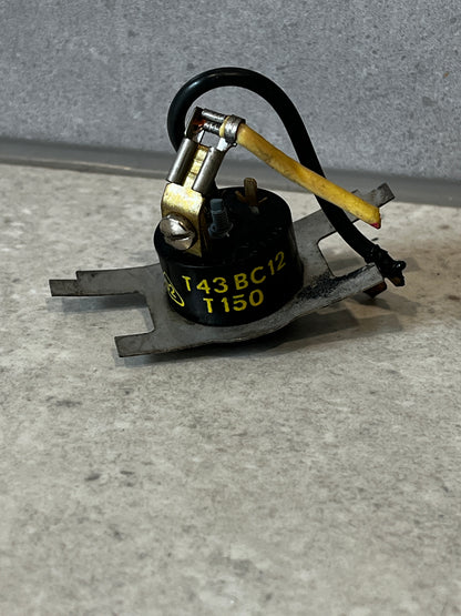 Front view of metal high-temperature thermal switch with wiring and connectors