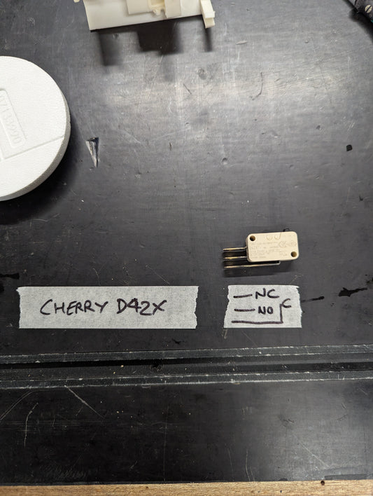 Cherry D42X micro switch with labeled terminals on workbench