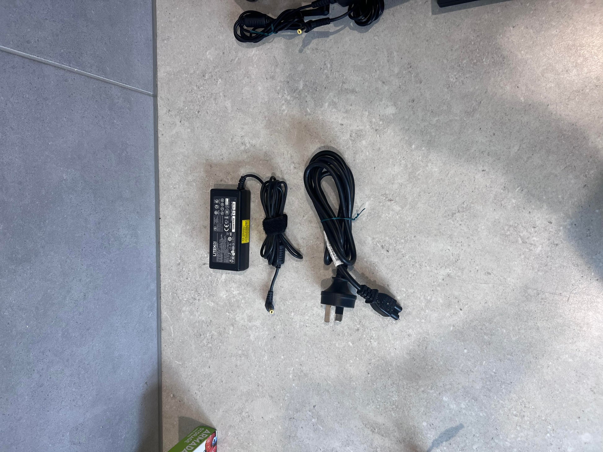 LiteOn PA-1650-02 laptop power adapter with AC cord on table