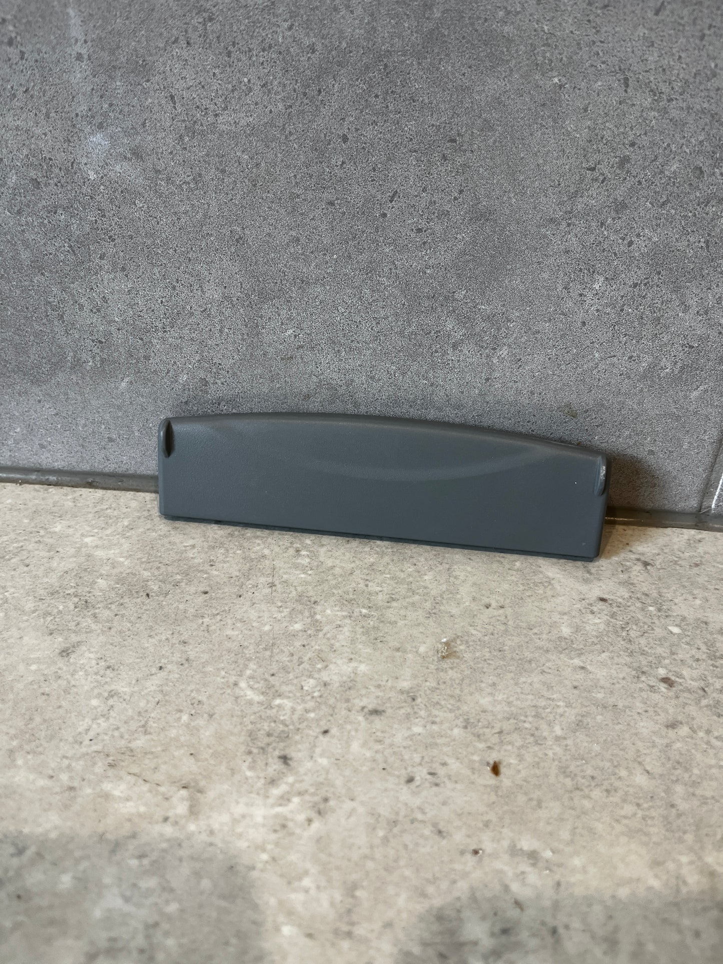Front view of gray plastic replacement drawer handle