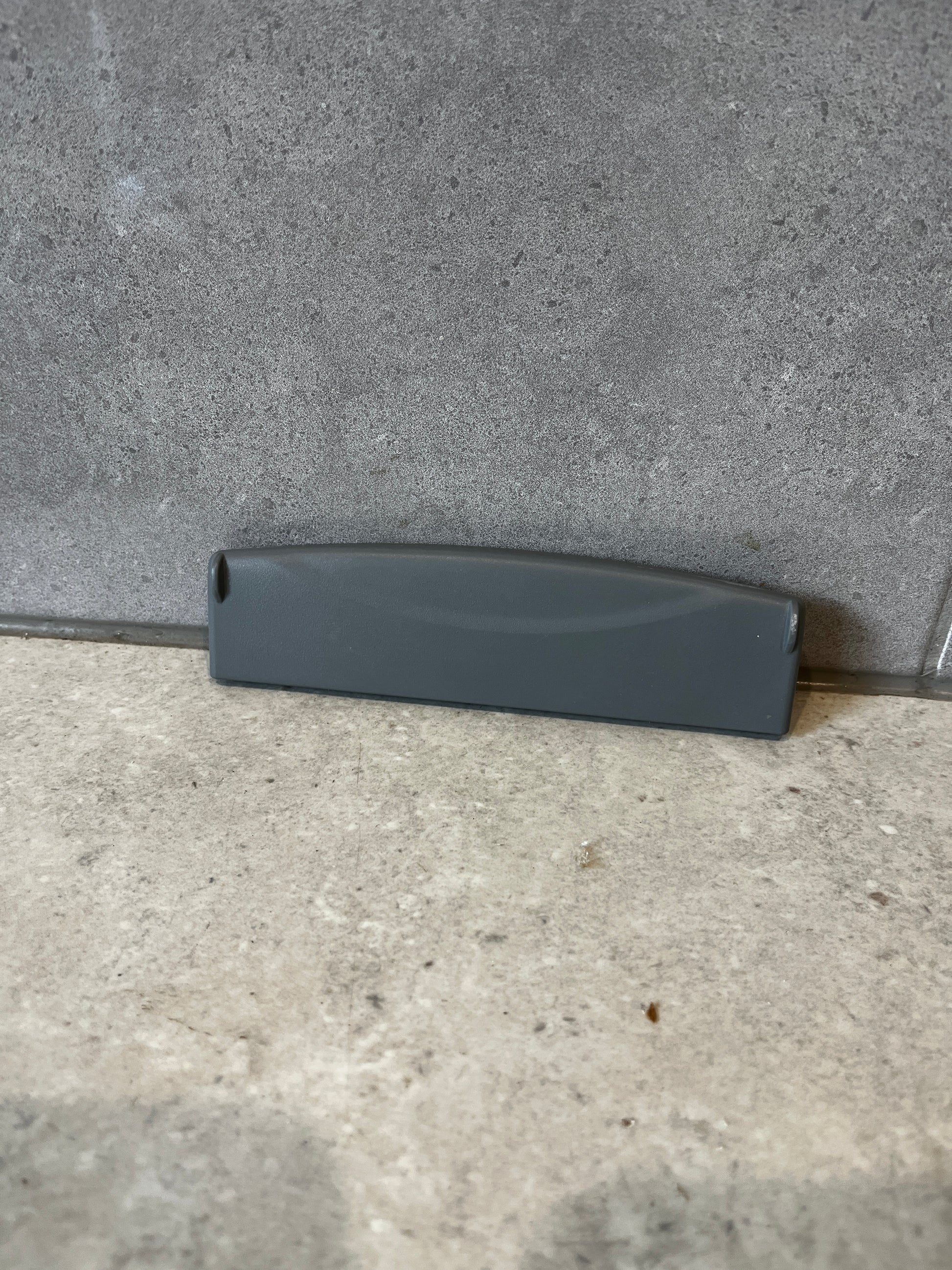 Front view of gray plastic replacement drawer handle