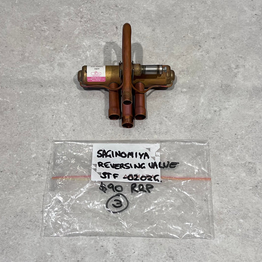 Saginomiya STF40202G reversing valve with labeled bag on gray surface