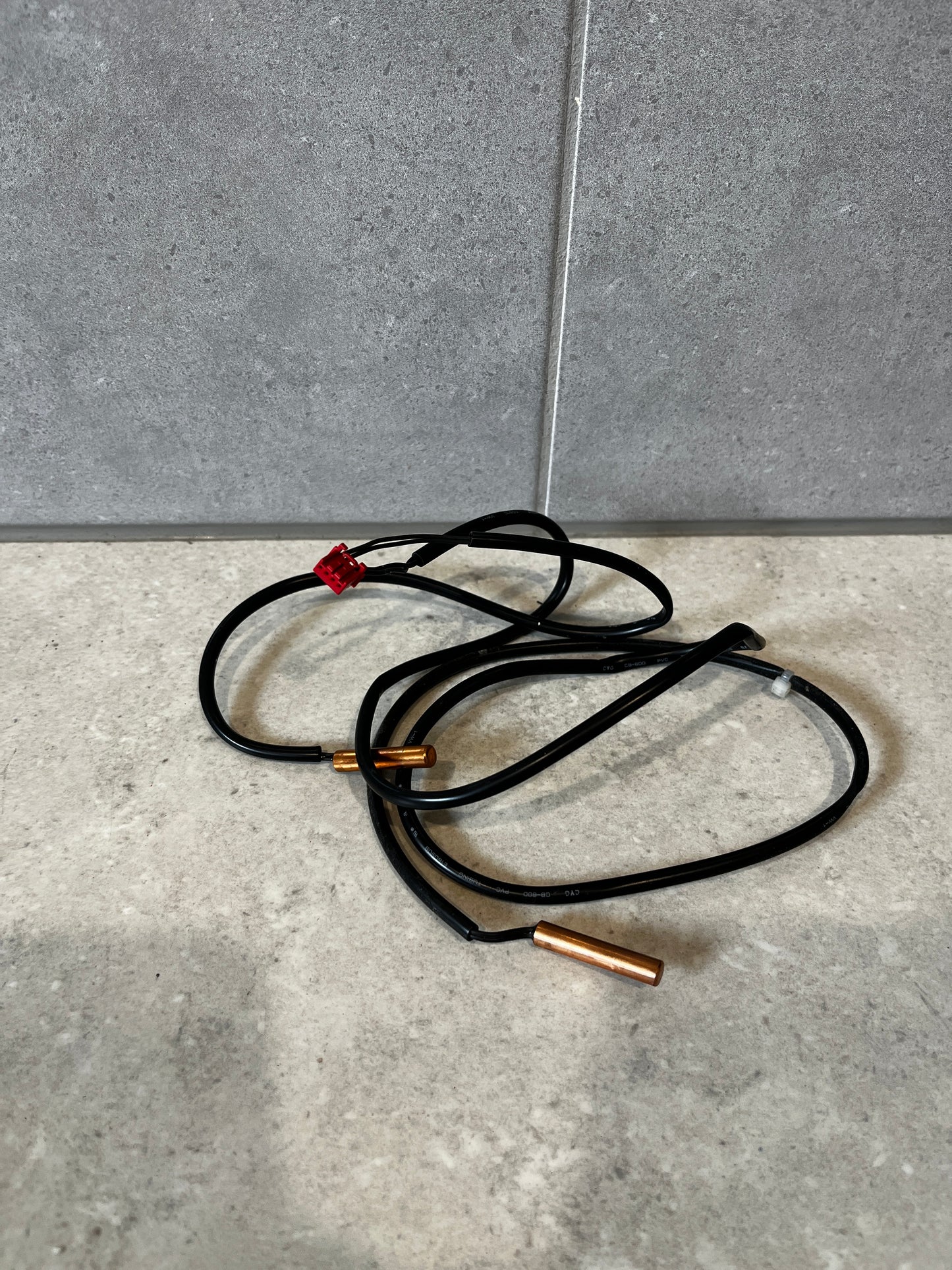 Waterproof temperature sensor with black cable and red connector