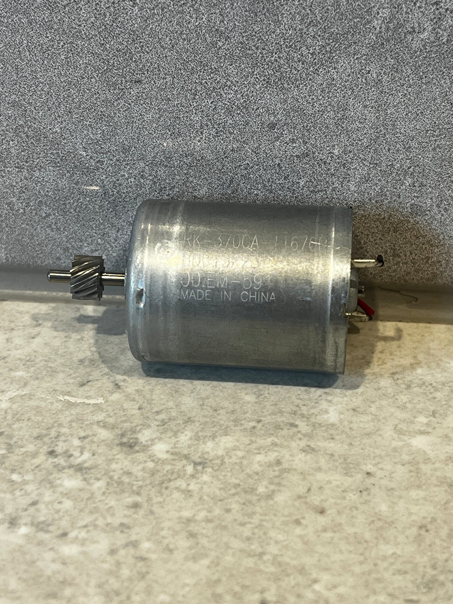 RK-370CA DC motor showing helical gear and metal housing close-up