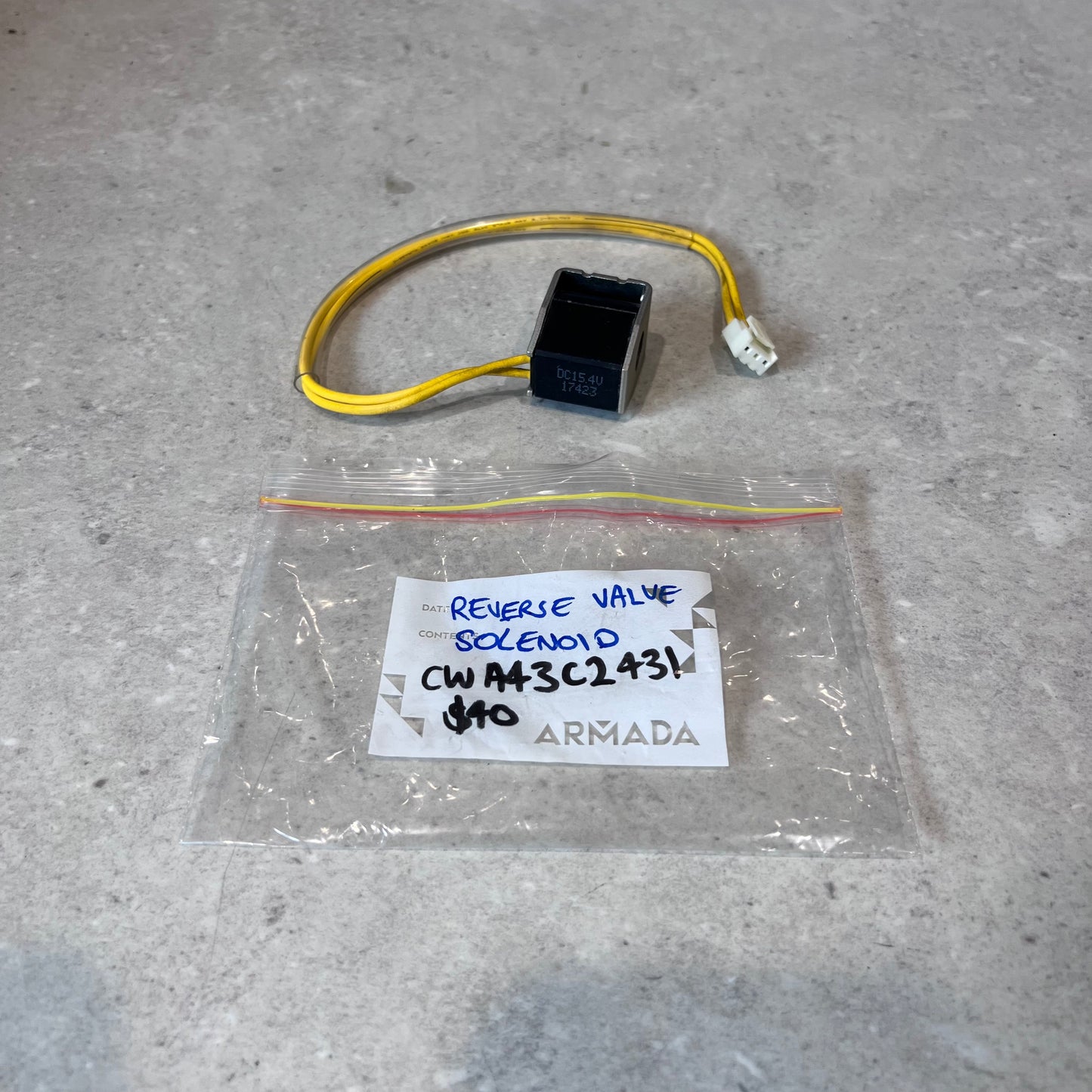 Reverse valve solenoid with yellow wire and clear ARMADA labeled plastic bag