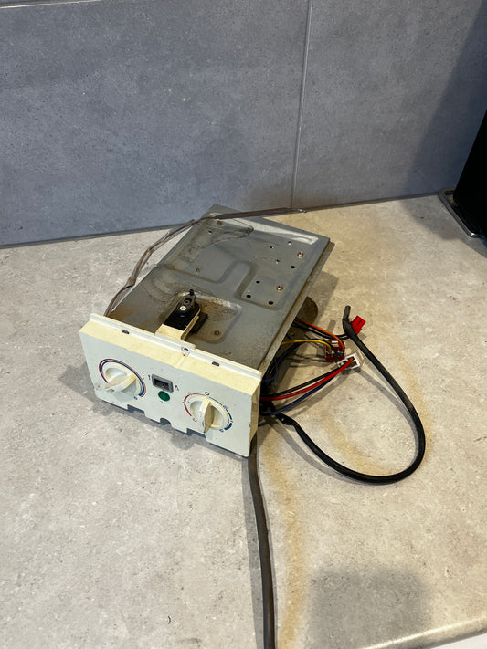 Thermostat control panel assembly with dual knobs and wiring harness on countertop