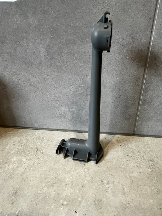 Dishwasher lower spray arm support standing upright on a tiled surface