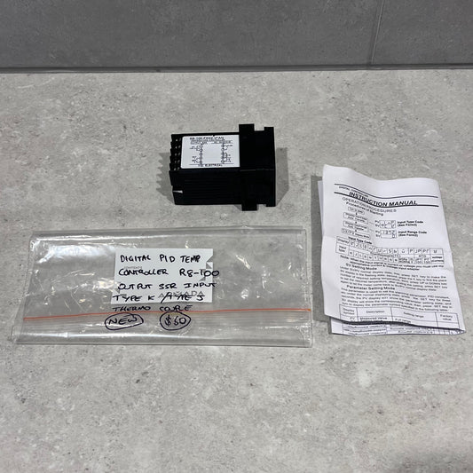 SHYB R8-100 Digital PID Temperature Controller with instruction manual and labeled storage bag on a countertop