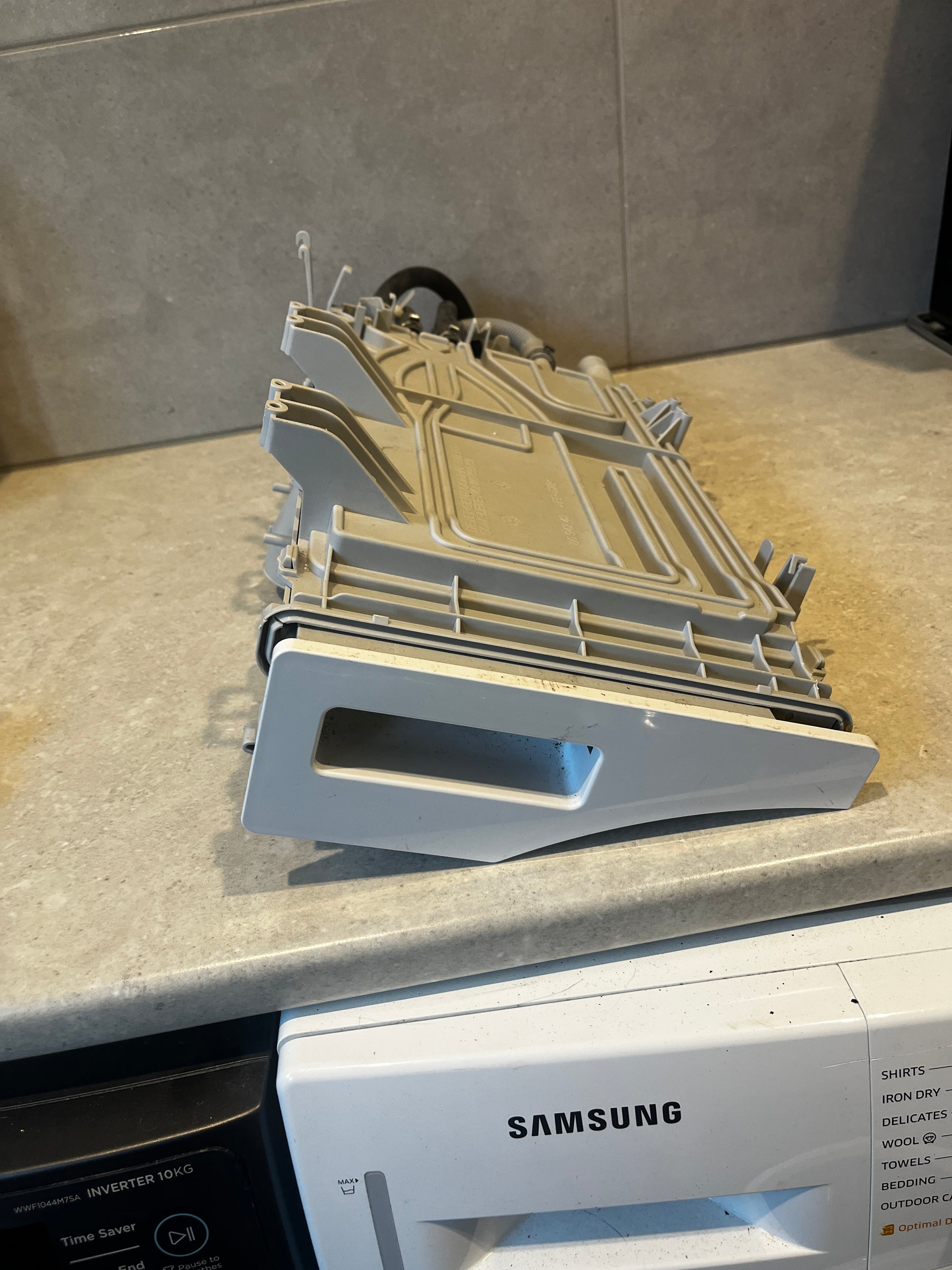 Samsung washing machine detergent drawer assembly on countertop