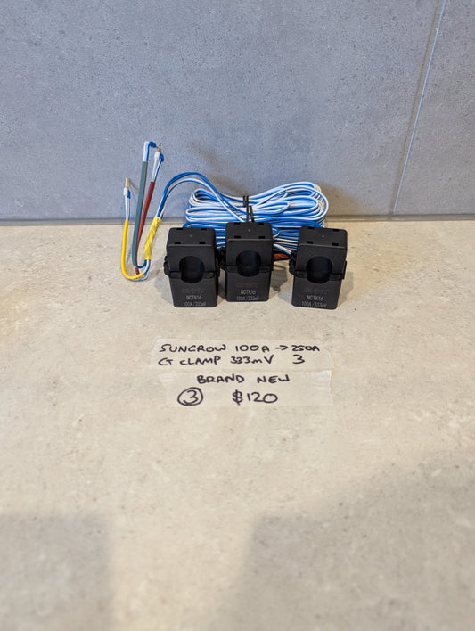 Set of three Sungrow MCTK16 CT clamps with attached wires on a light surface