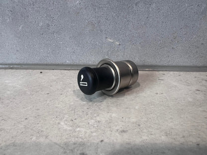 Automotive cigarette lighter socket plug with black cap and metal body, side view