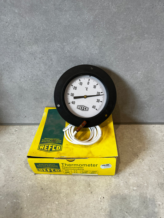 REFCO analog panel thermometer with white dial and black frame on yellow product box