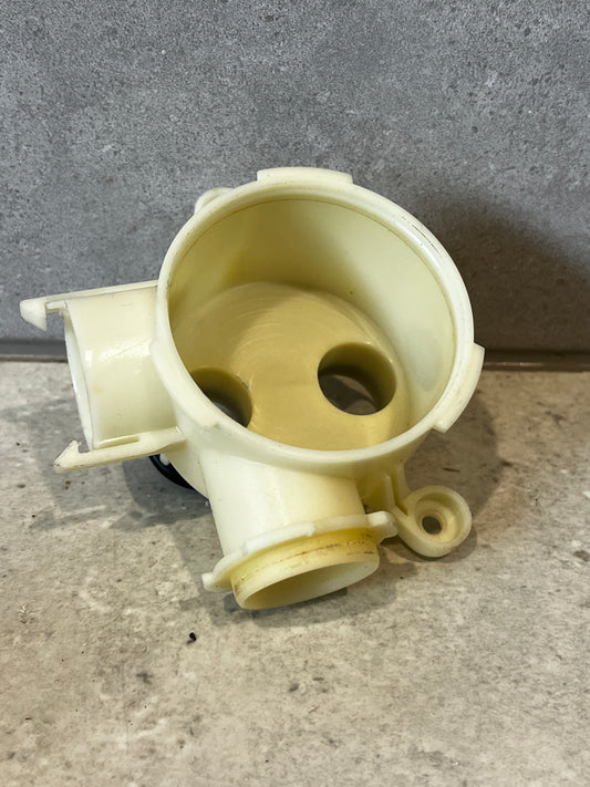 Front view of plastic water pump housing with circular openings