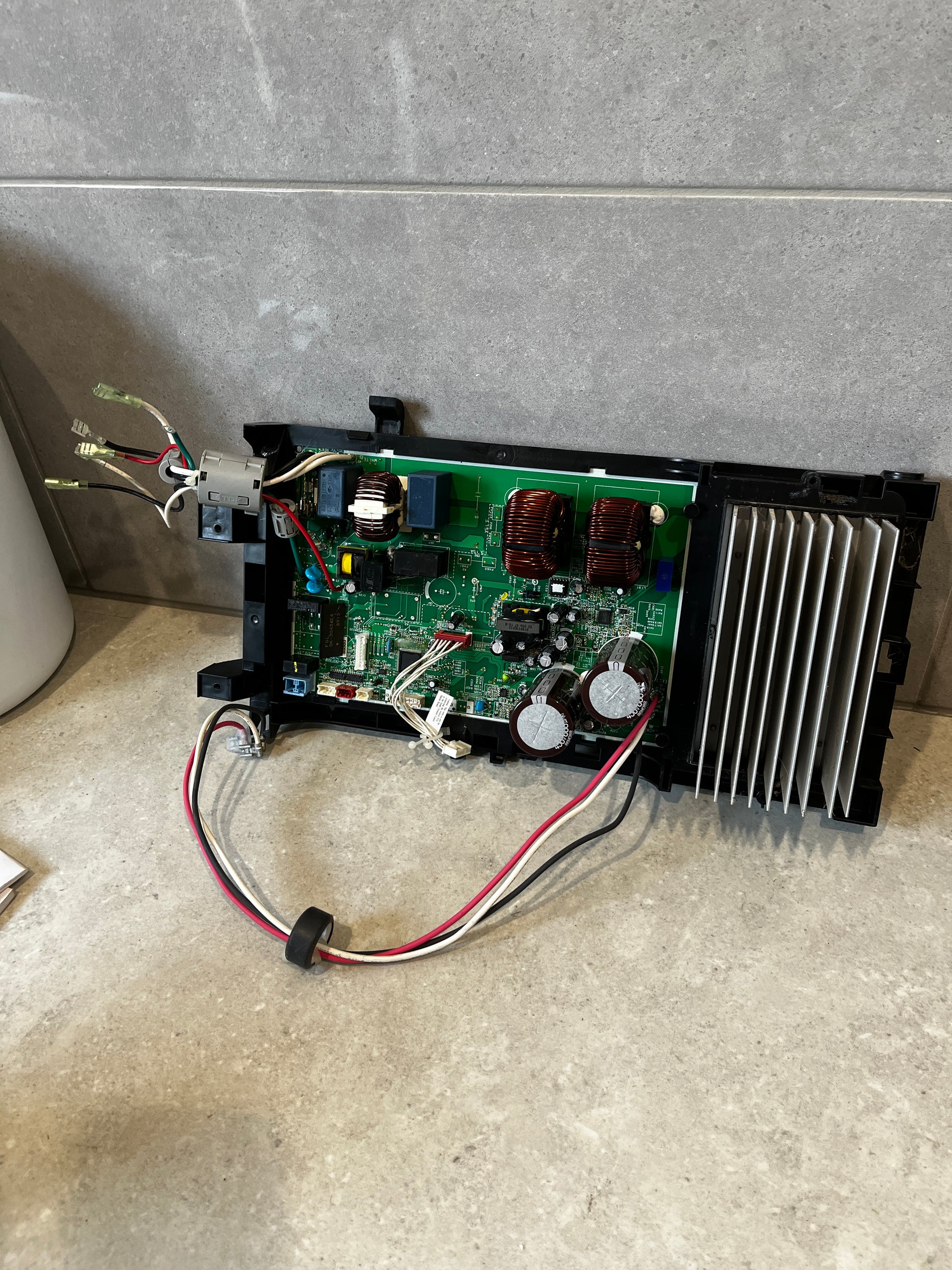 Electronic power control board with wiring and large heat sink on stone surface