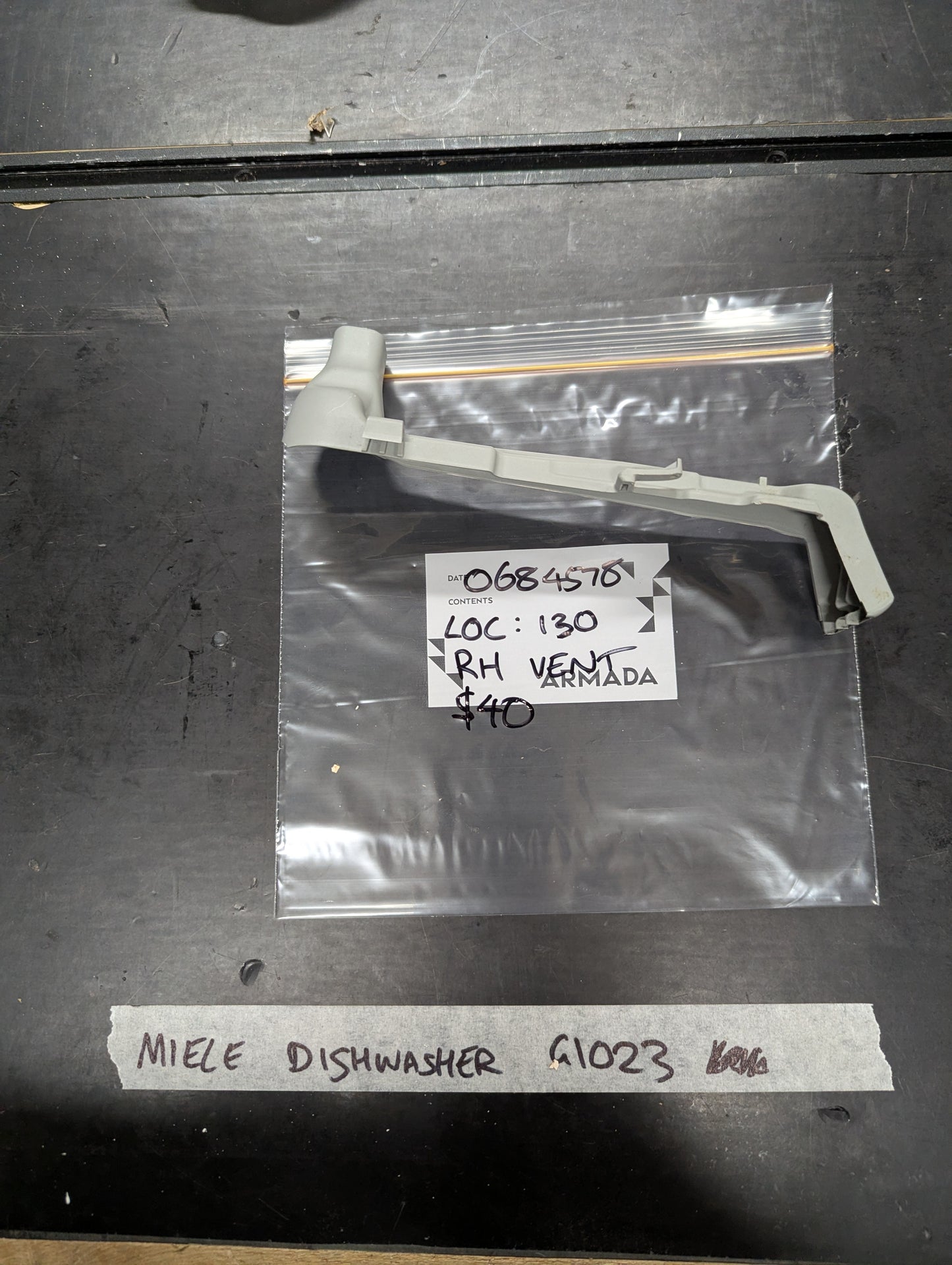 Miele G1023 dishwasher vent arm replacement on plastic bag with label