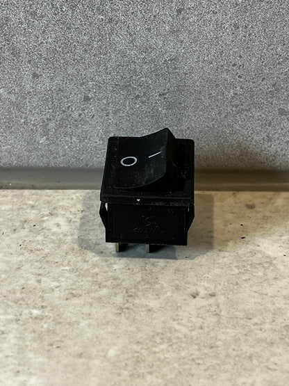 Front view of a black rocker switch with on-off markings