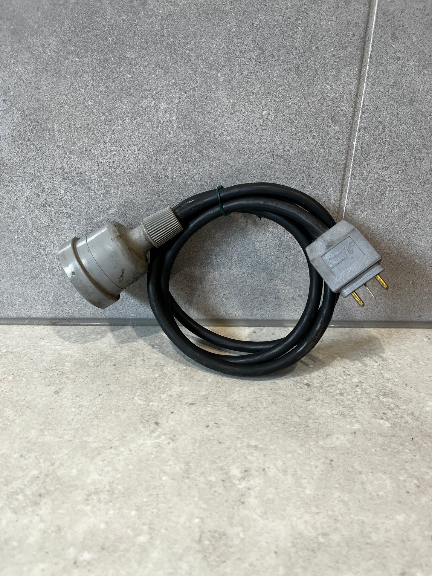 Indu Electric heavy-duty power cable coiled on a concrete surface
