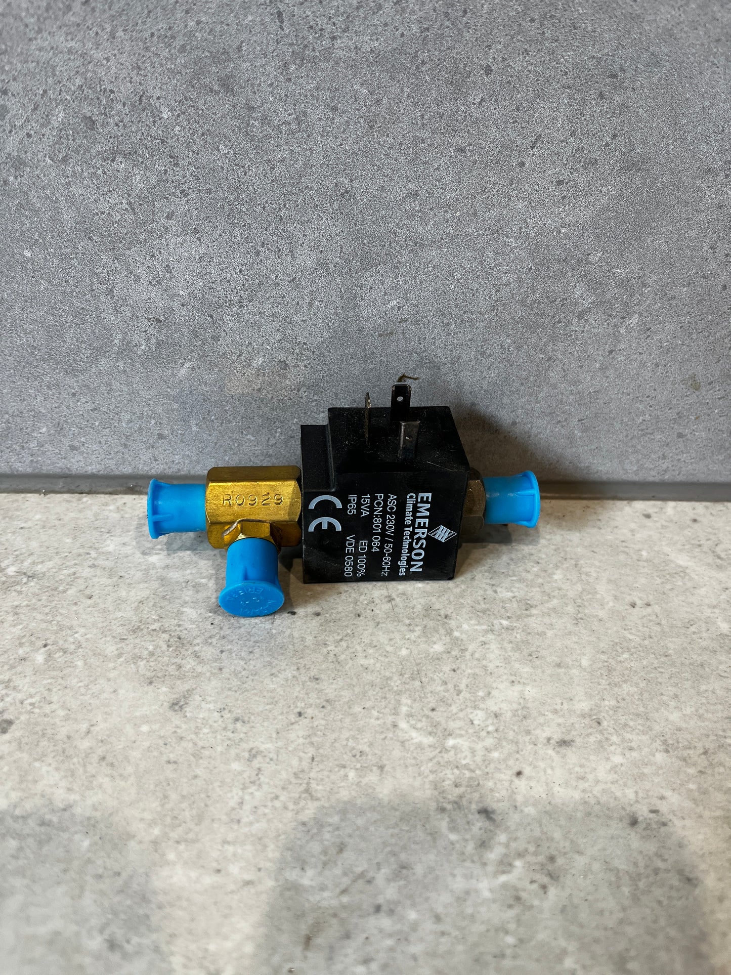 Front view of Emerson 702RA-001 refrigeration solenoid valve with blue caps