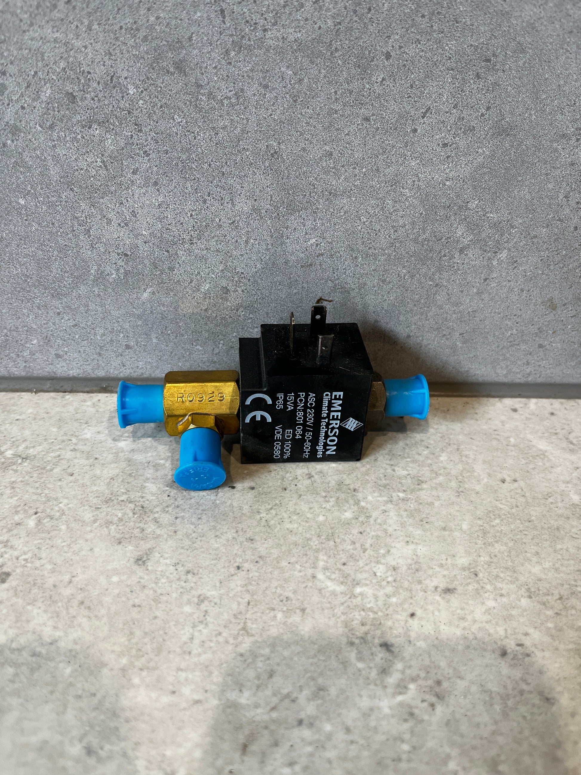 Front view of Emerson 702RA-001 refrigeration solenoid valve with blue caps