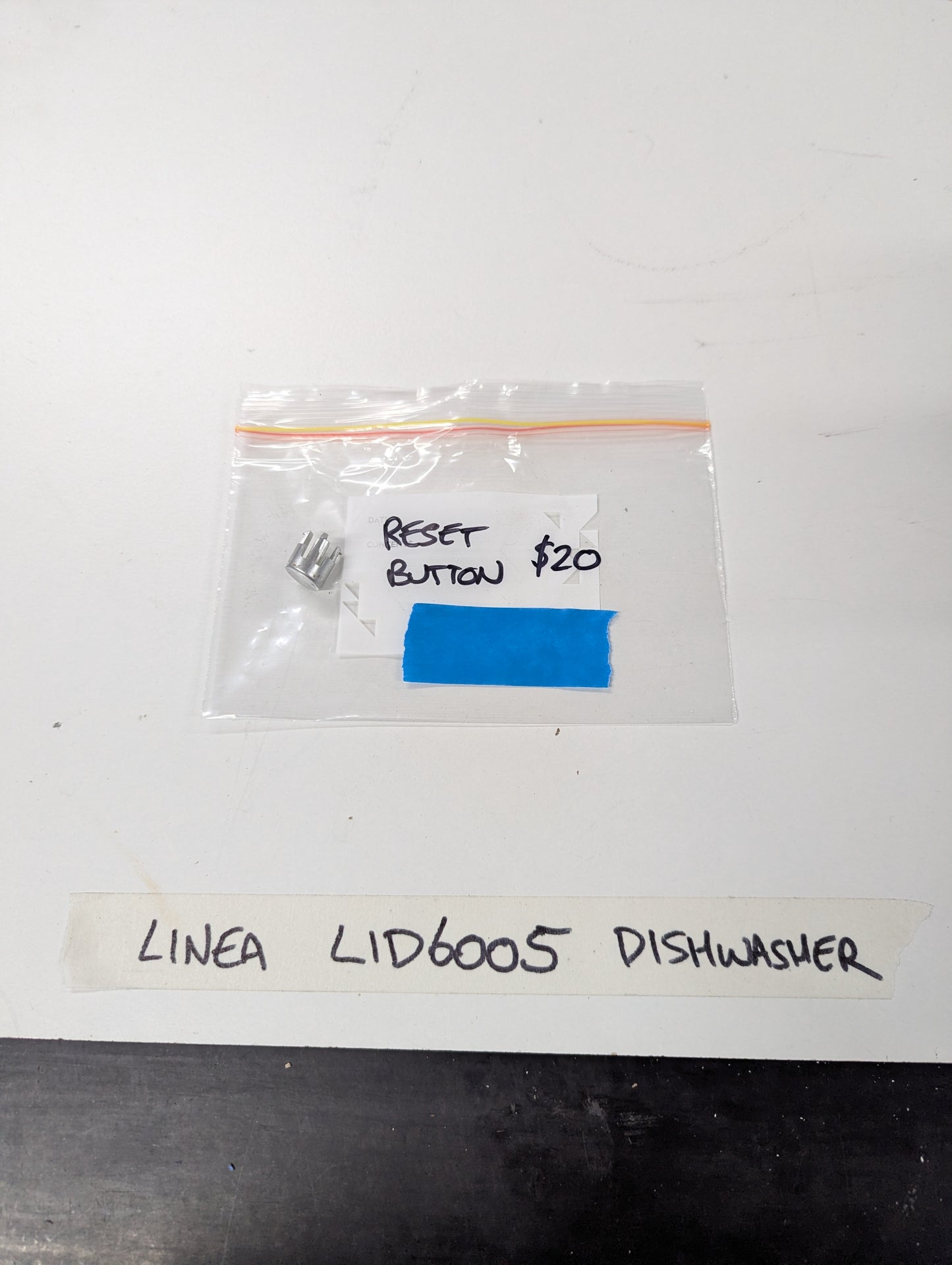Linea LID6005 dishwasher reset button in labeled plastic bag