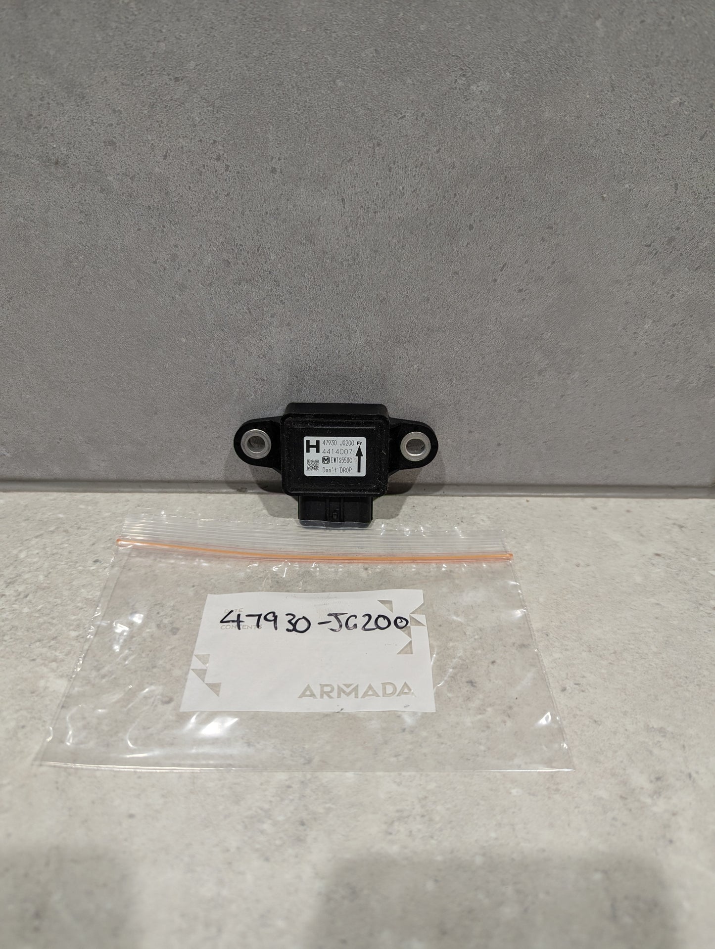 Nissan Armada yaw rate sensor 47930-JG200 with labeled zip bag