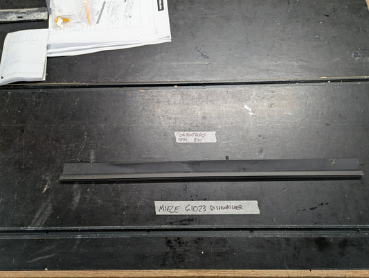 Miele G1023 dishwasher black rubber door seal on workbench with label