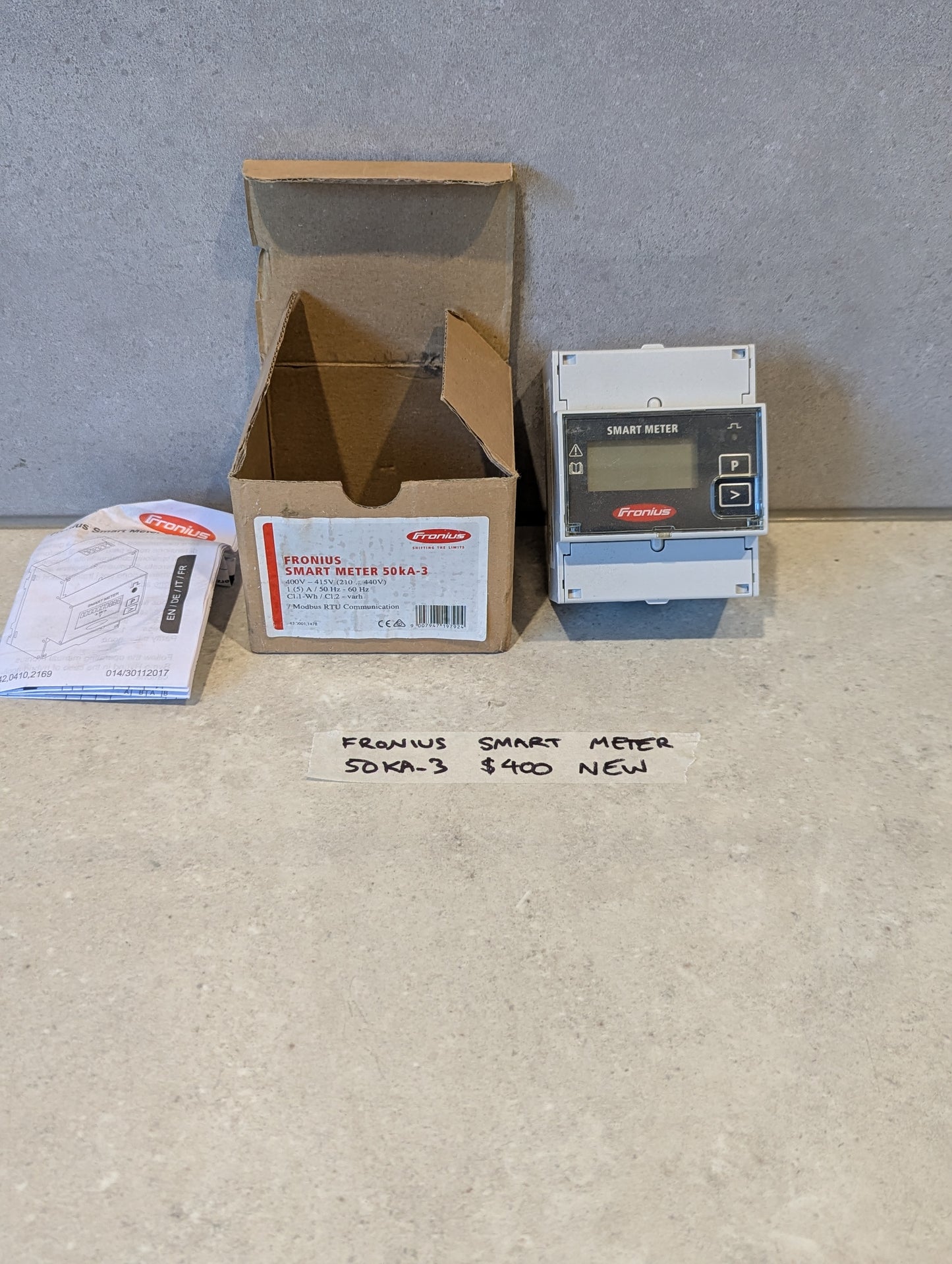 Fronius Smart Meter 50KA-3 with box and manual on countertop