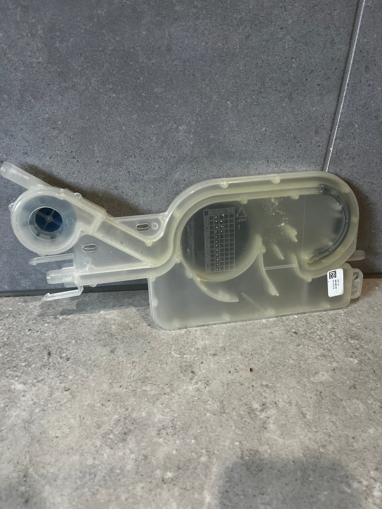 Dishwasher water inlet valve assembly on a stone surface
