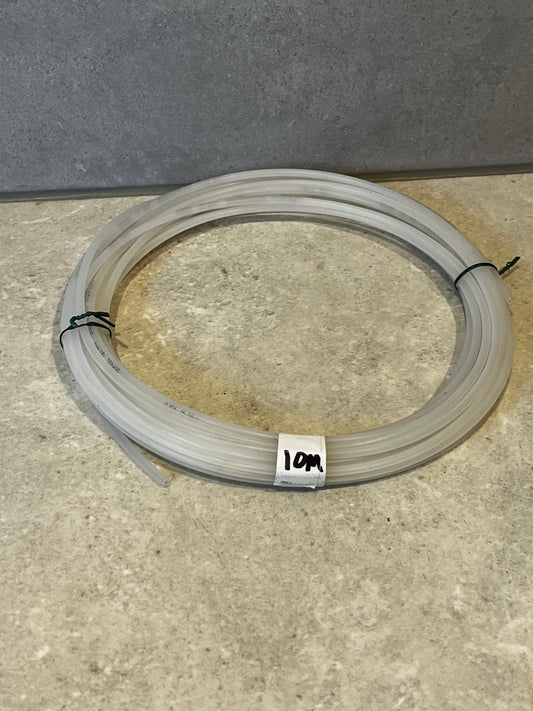 Coiled 10-meter polyethylene tubing on a stone surface