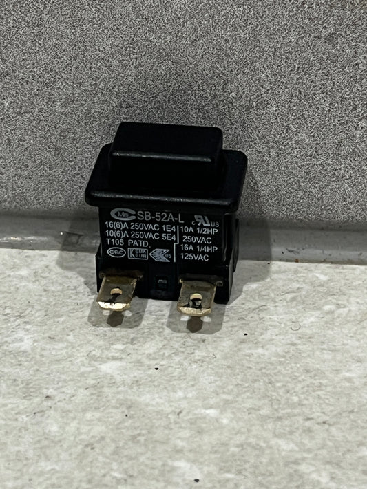 black SB-52A-L power switch with two metal terminals on gray surface