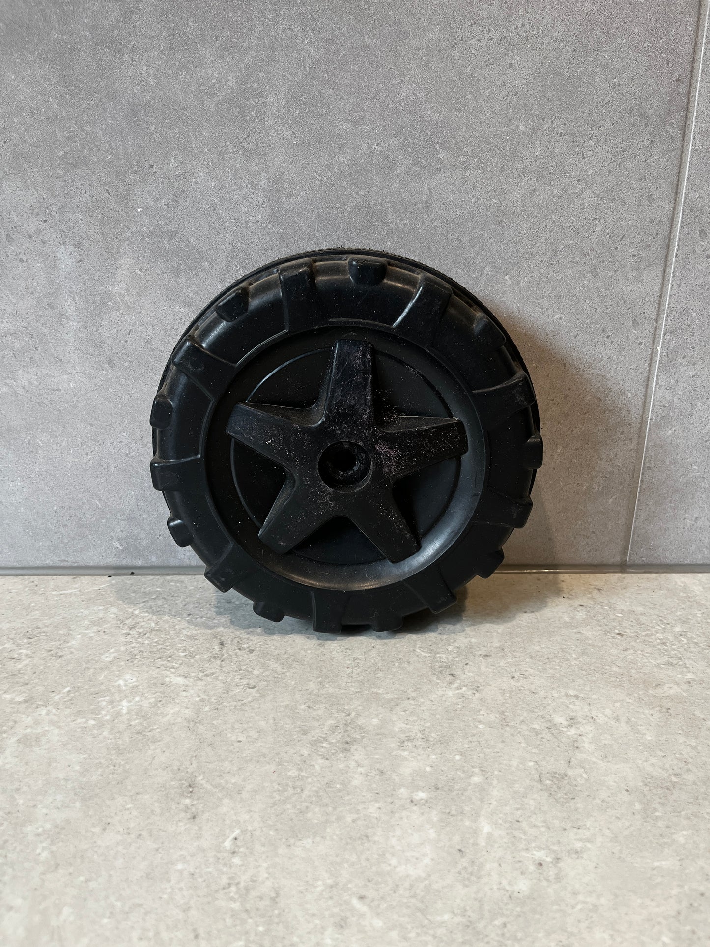 Black durable replacement wheel for garden cart with deep tread pattern