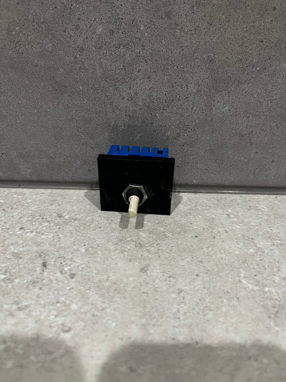 Electronic toggle switch module with black and blue housing and white lever