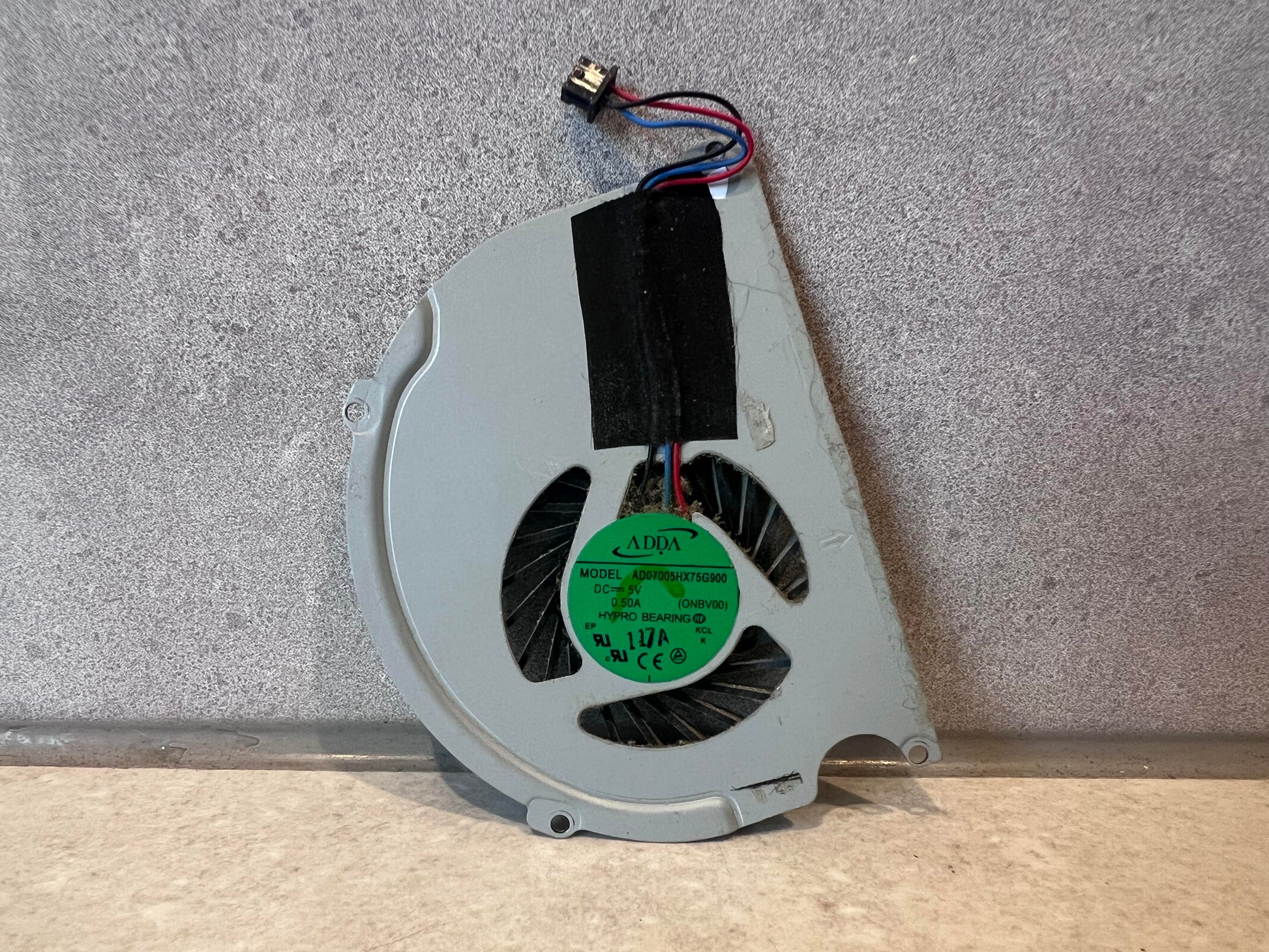ADDA laptop cooling fan showing connector and label
