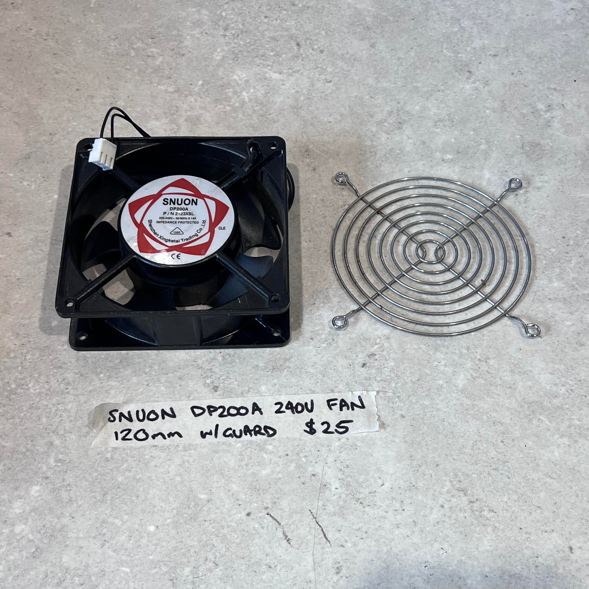 SNUON DP200A 240V 120mm fan with metal wire guard on a light surface