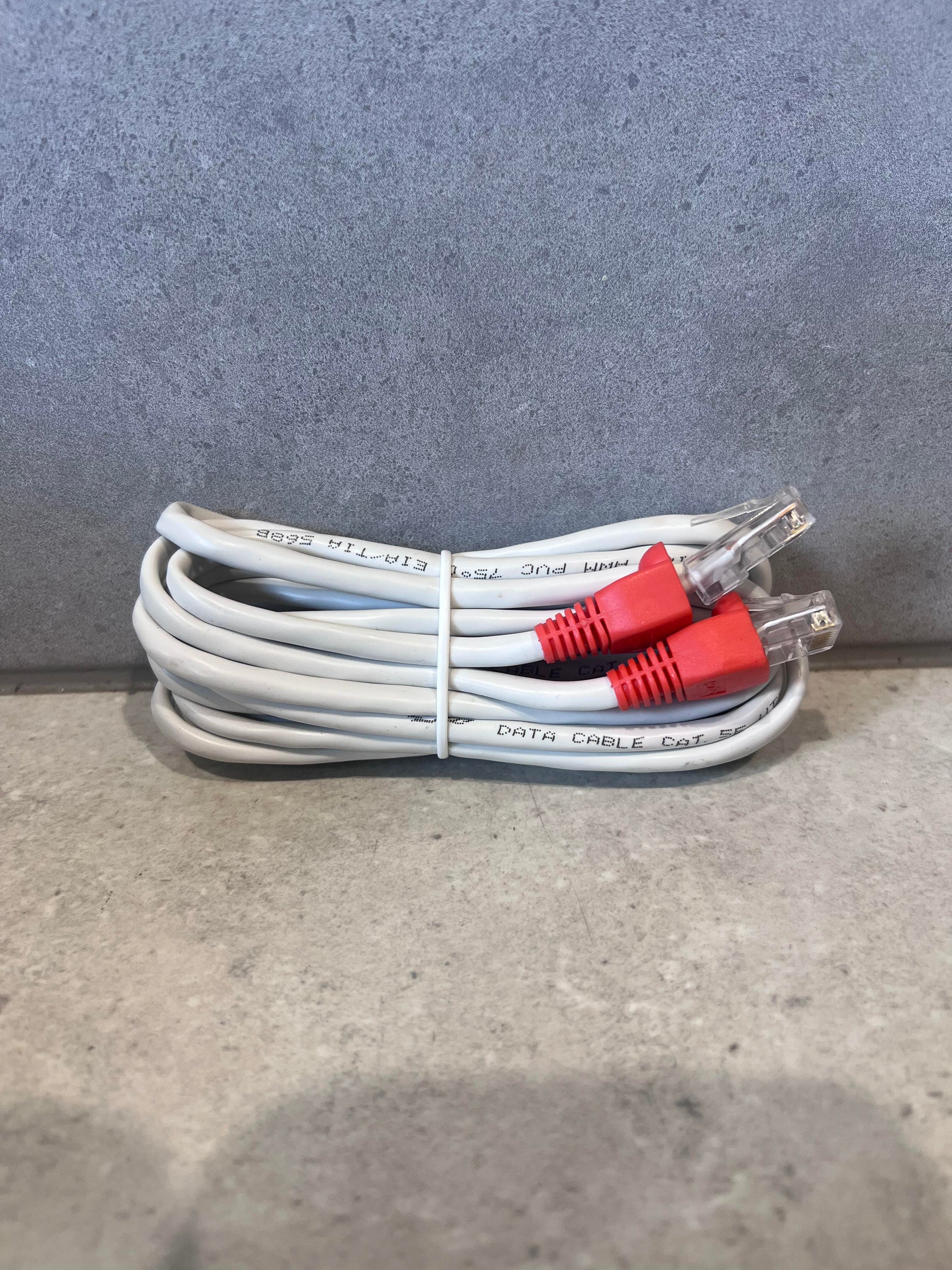 Coiled CAT 5E Ethernet cable with red RJ45 connectors