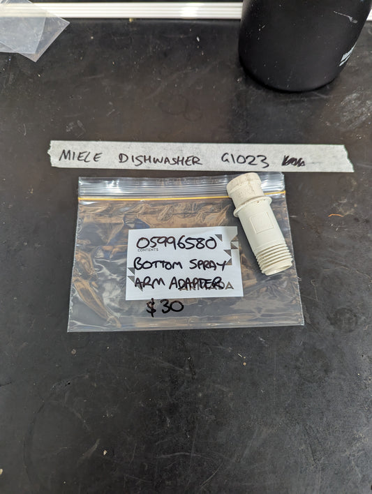 Miele Dishwasher G1023 bottom spray arm adapter with labeled bag on black surface