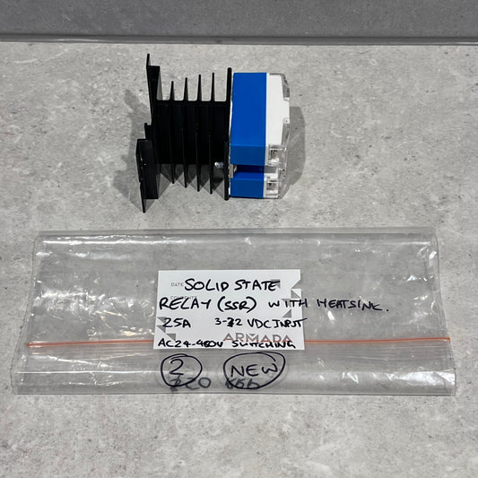 Solid state relay with heatsink and labeled bag on a gray surface
