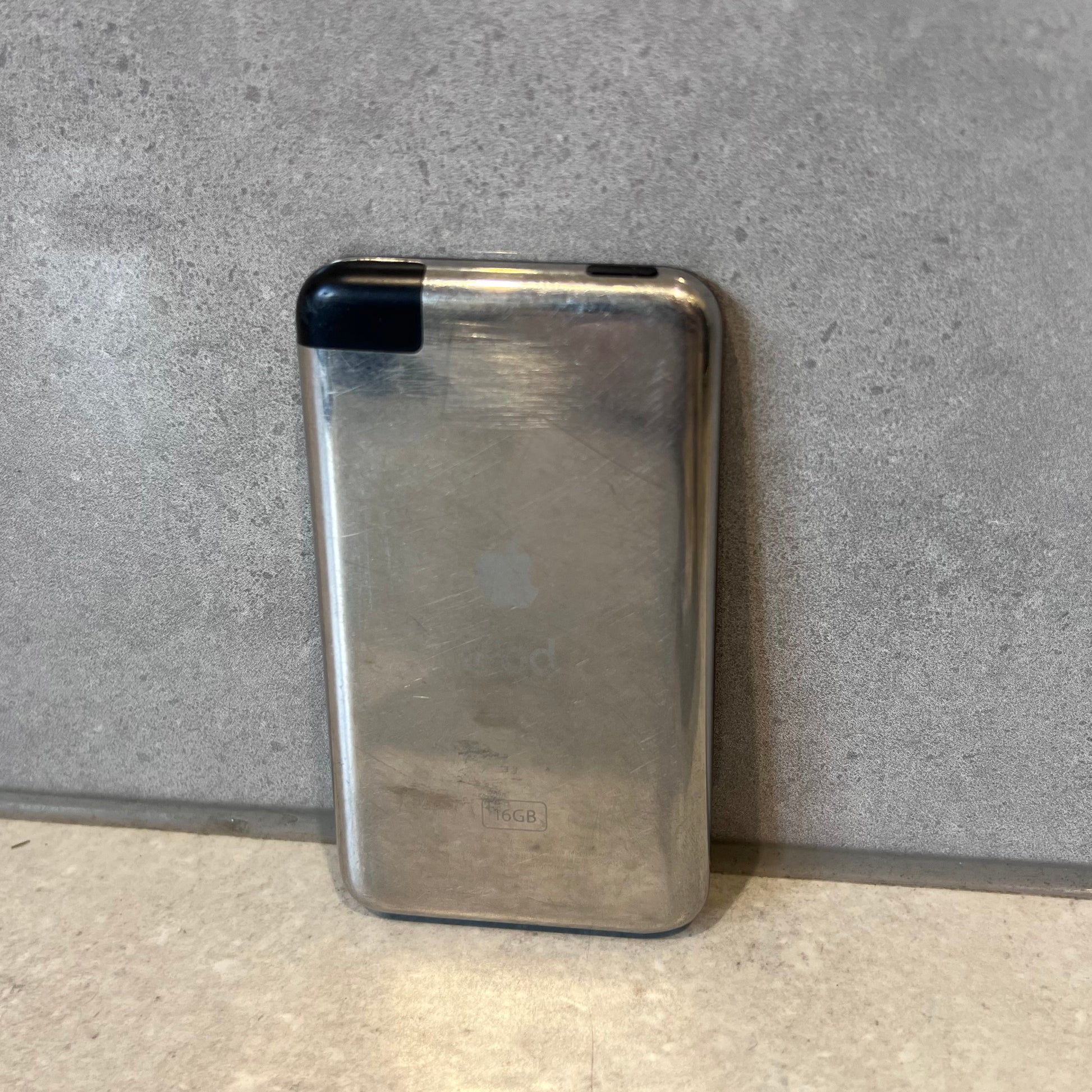 Apple iPod Touch showing scratched silver back casing with storage indication