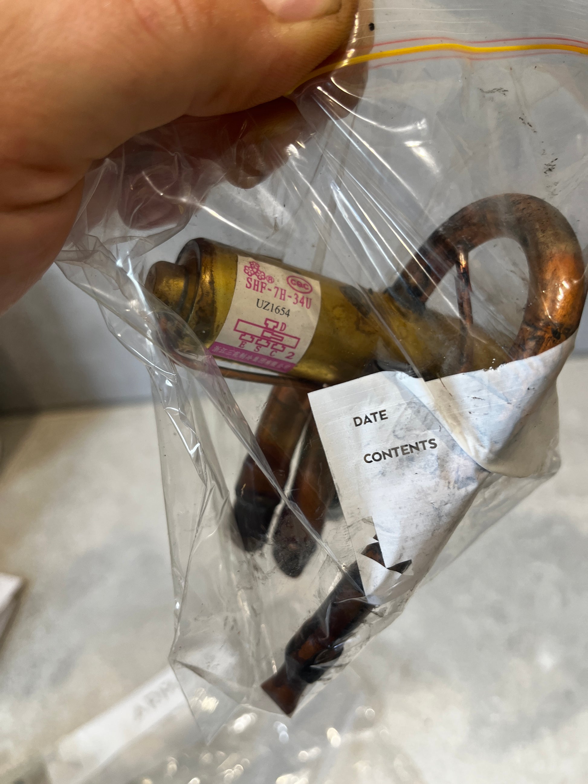 SHP-7H-34V brass and copper refrigerant expansion valve in plastic packaging