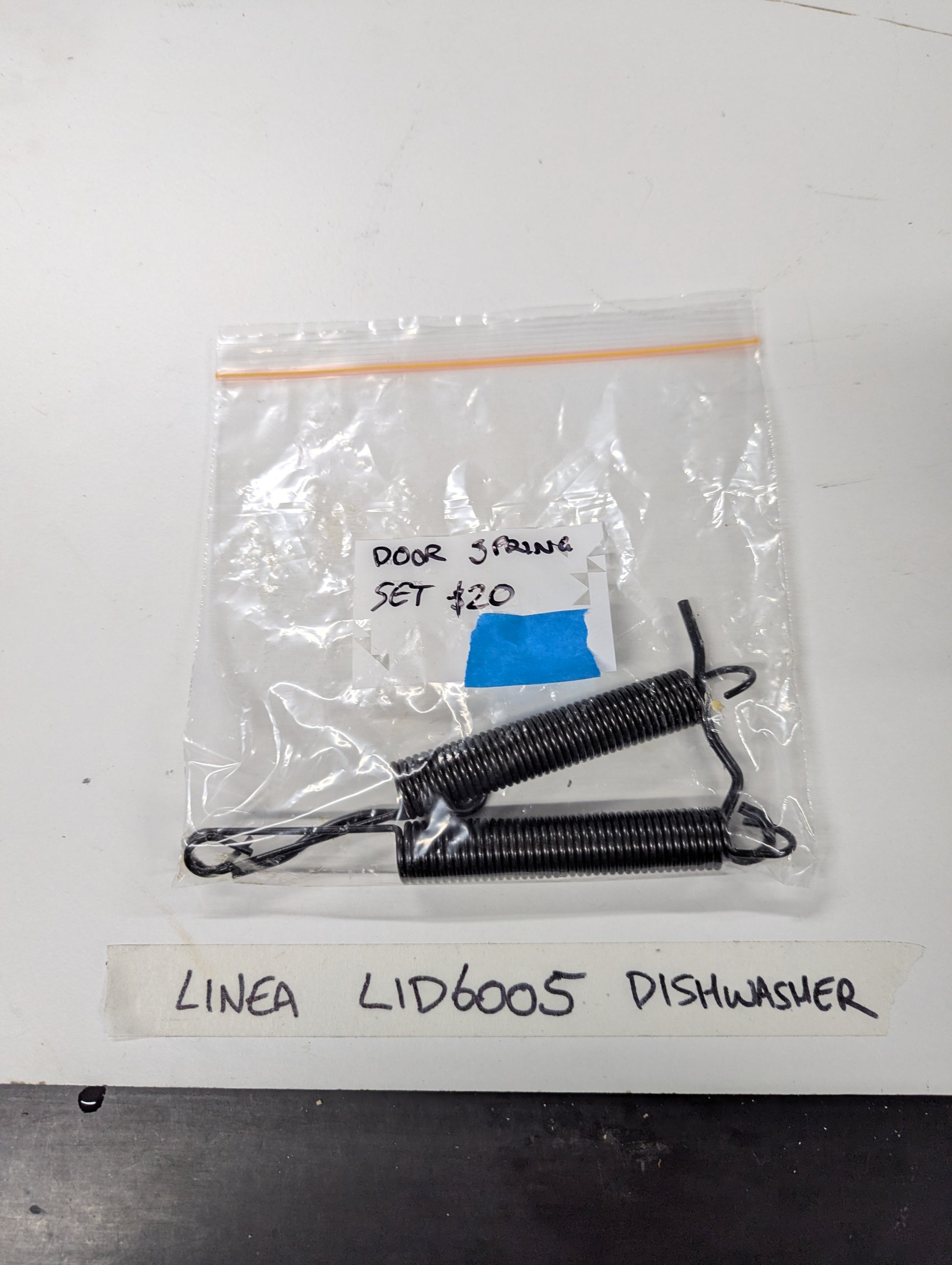 Set of two black door springs in a clear plastic bag labeled for Linea LID6005 dishwasher
