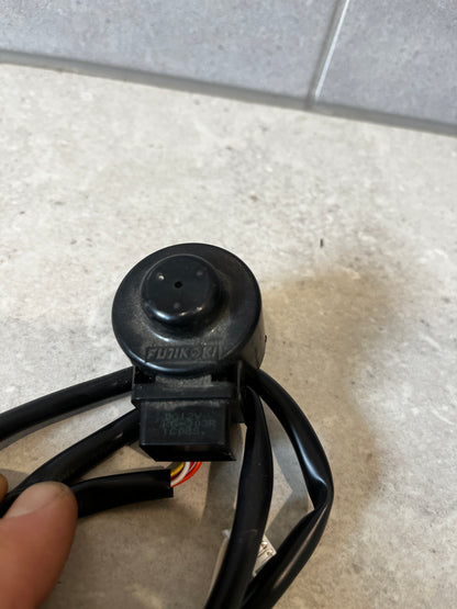 Close-up of Fujikoki solenoid valve and connector on gray background