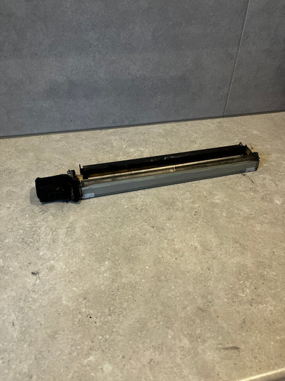 Top view of printer fuser assembly replacement showing black and metallic parts