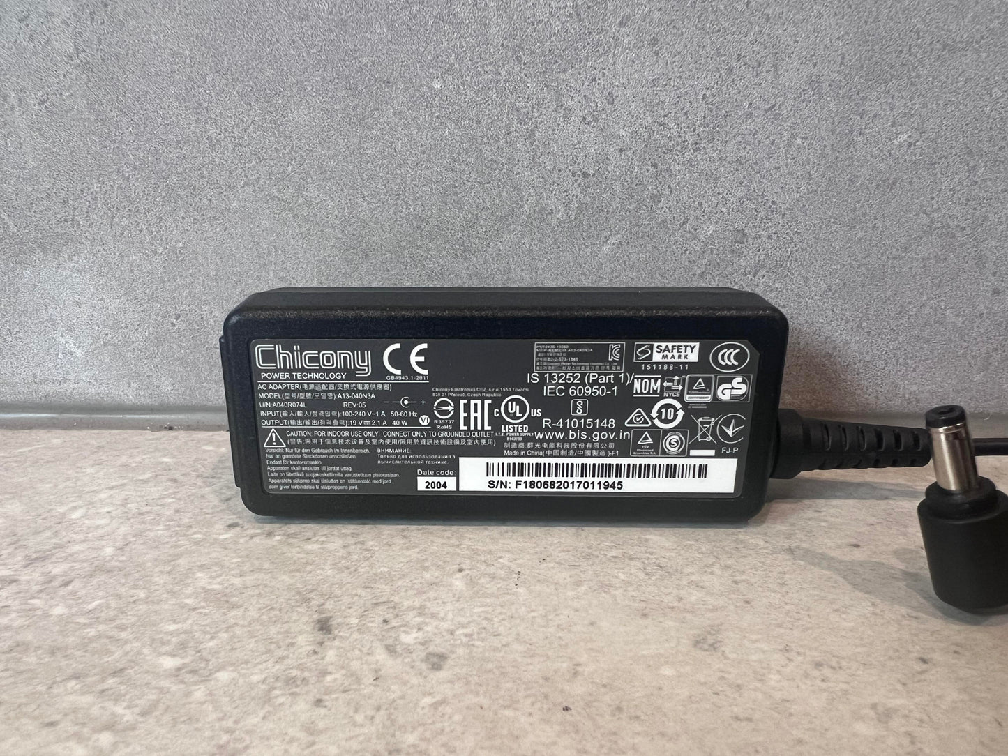 Close-up of Chicony 40W laptop power adapter product label