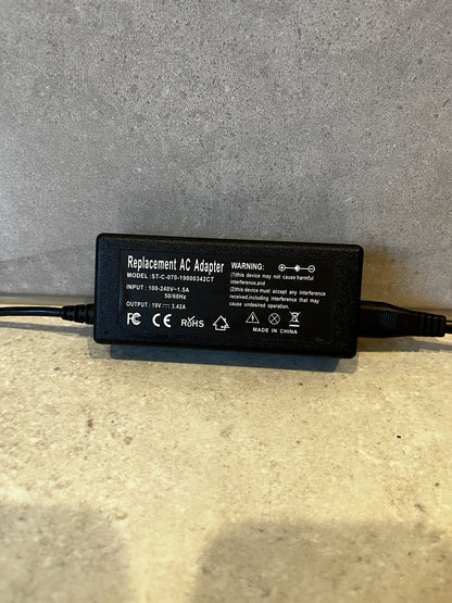 Close-up of Replacement AC Adapter label showing input and output specifications