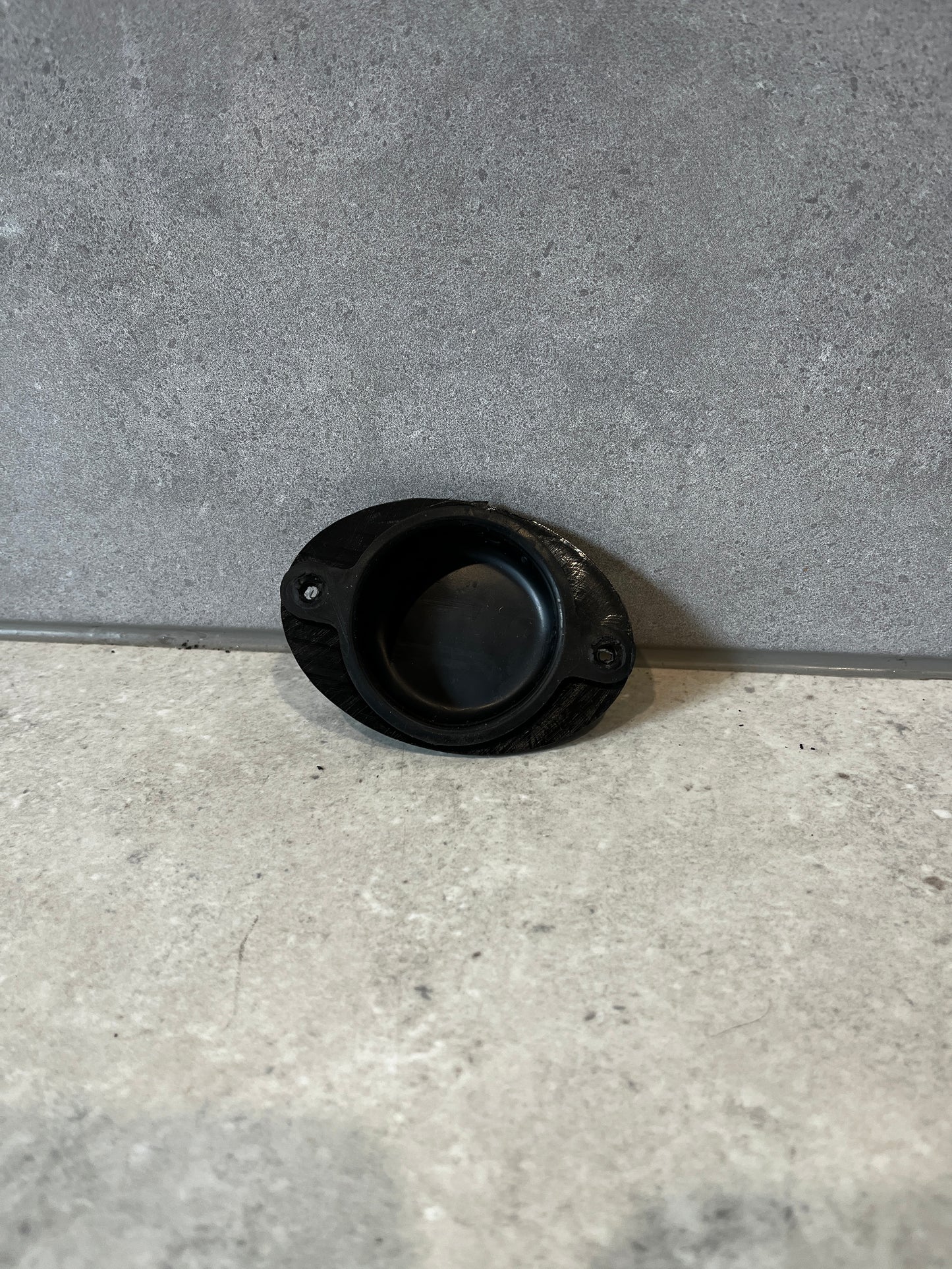 Black rubber door stop in open position showing impact surface