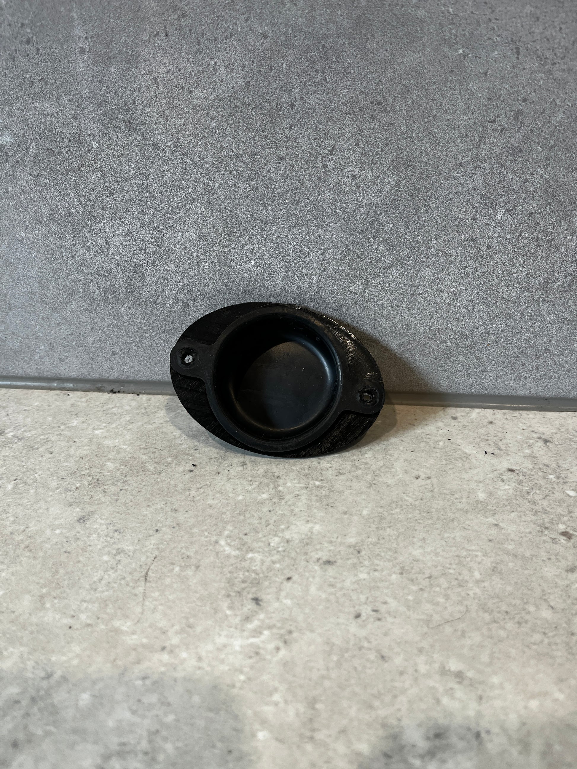 Black rubber door stop in open position showing impact surface