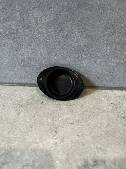 Black rubber door stop in open position showing impact surface