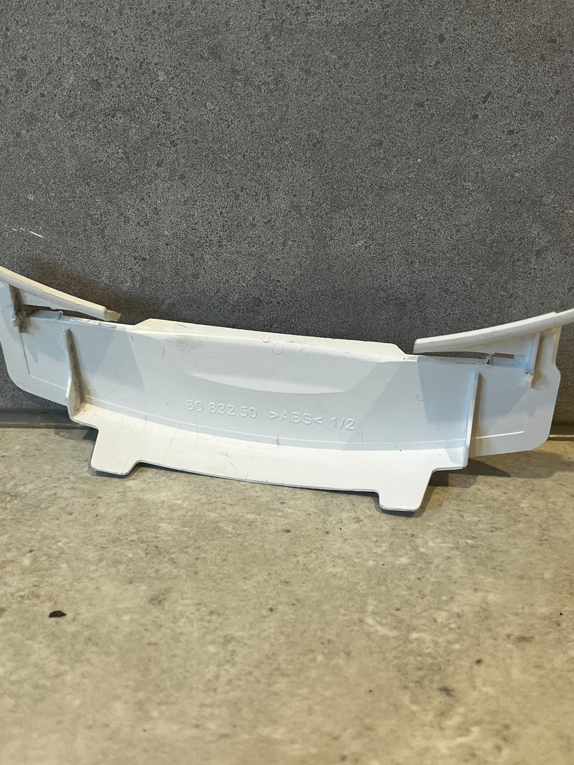 Back view of white ABS plastic appliance cover showing model number